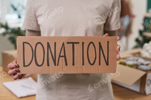 Preview: Unrecognizable Woman With Donation Sign