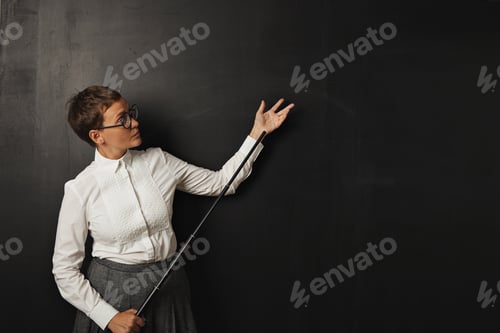 Preview: Female teacher with pointer at blackboard