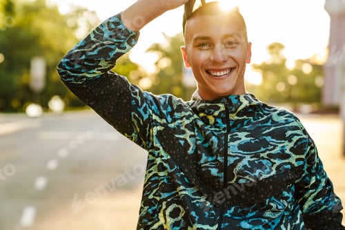 Preview: Young sportsman smiling while working out at down
