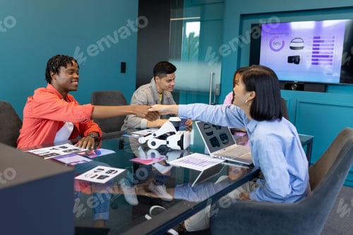 Preview: Business team discuss VR, startup, teamwork, and collaboration while shaking hands