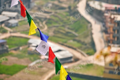 Preview: Colorful Tibetan prayer flags on blurred Kathmandu cityscape background
