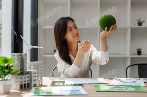 Preview: Woman holding green sphere symbolizing environmental sustainability and urban planning