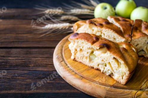 Preview: Round home-made apple pie, cobbler, brown Betty, Apple Charlotte on wooden background with apples
