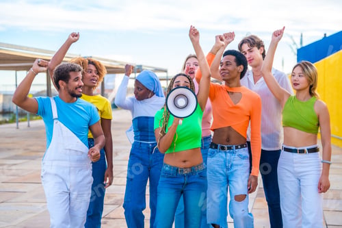 Preview: Young people yelling using a loudspeaker in a protest