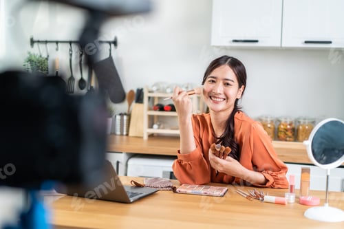 Preview: Asian female vlogger talk with camera to review the cosmetic at home.