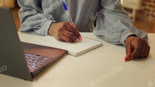 Preview: Blogger writing story ideas on notebook