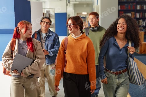 Preview: Group of Diverse Teenagers Walking Together and Smiling in School Hallway
