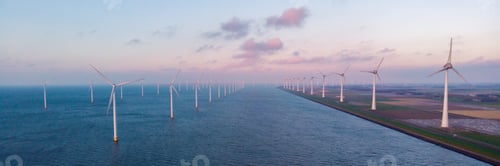 Preview: Windmill turbines at sea seen from a drone aerial view from above at a huge winmill park