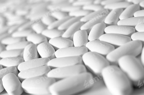 Preview: Macro close-up of many white pills, medication concept