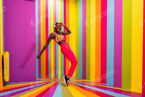 Preview: Beautiful young woman dancing and having fun inside a rainbow box room