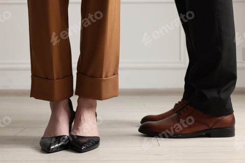 Preview: Businessman and businesswoman in elegant shoes indoors, closeup