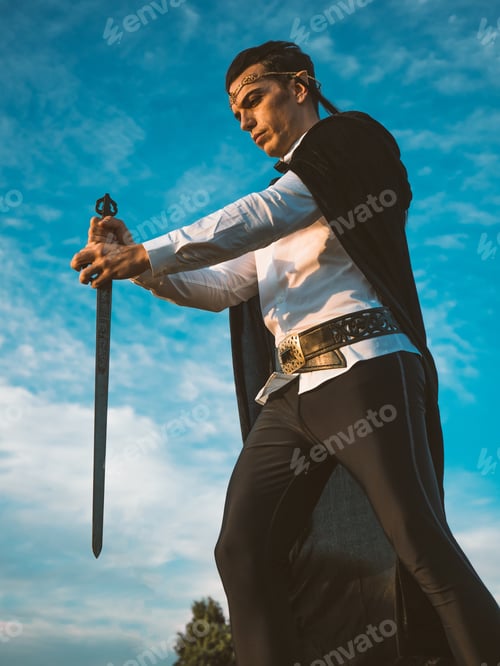 Preview: Brown-haired man with elf ears, carrying a sword in his hands.