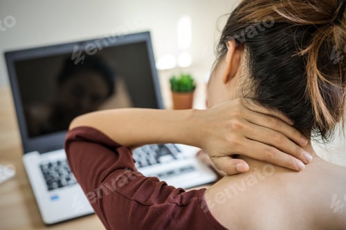 Preview: Young woman working at home and having neck pain