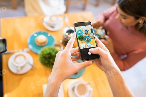 Preview: Man Capturing Food Photos On Cellphone In Cafe