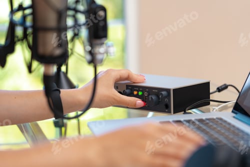Preview: Unrecognizable young woman hands adjusting audio mixer setting sound in home studio close up