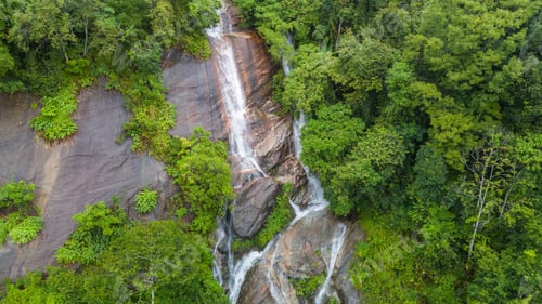 Preview: Aerial view of beautiful waterfall village in the lush green rain cloud and foggy cover