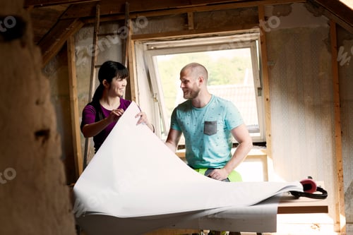 Preview: Two people reviewing plans during a home renovation