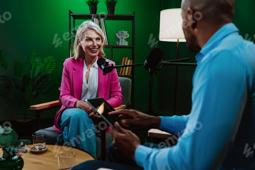 Preview: Content creators broadcasting live podcast interview using microphones