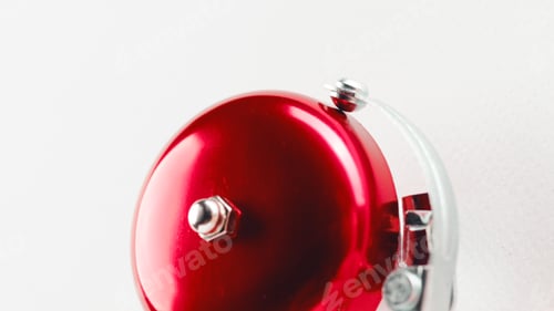 Preview: Red school bell on the white wall