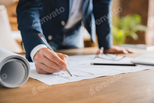 Preview: Architect engineer working on construction plan, dealing with blueprints on table at office