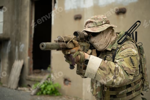 Preview: Special forces soldier in camouflage with a pair of weapons that are full of modern technology