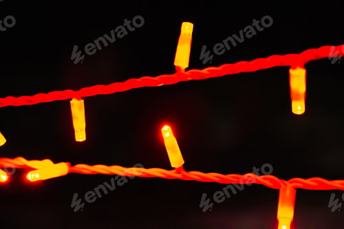 Preview: Lights of Christmas garland close-up on black background.