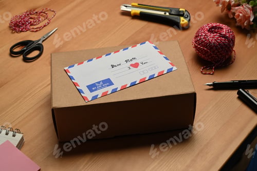 Preview: Cardboard boxes, greeting card, tape and clews of rope on wooden table.