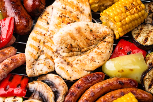 Preview: Grilled sausages, meat, and vegetables.