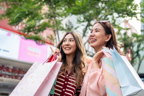 Preview: Asian young women shopping goods outdoor in shopping street at night.