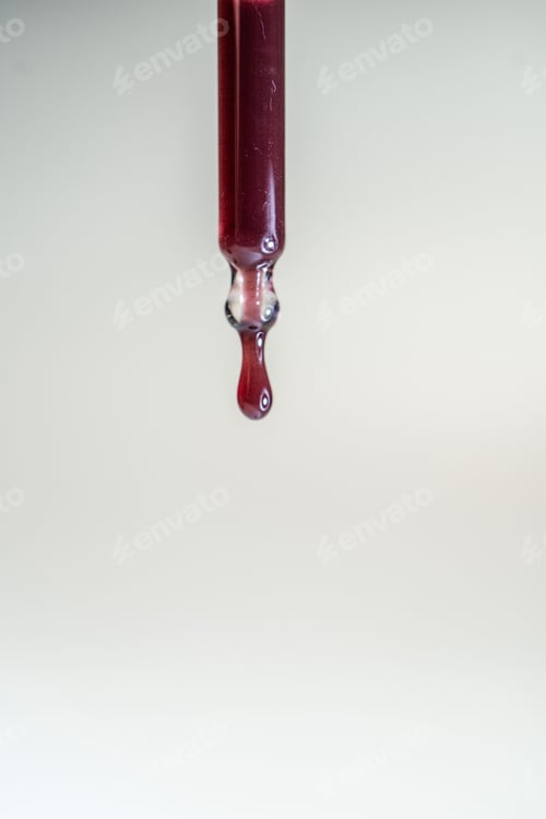 Preview: A drop of red serum drops from the pipette