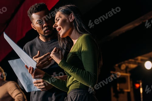 Preview: multiethnic actor and actress having rehearse on stage in theater