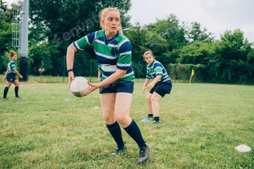 Preview: Rugby player in focus ready to pass the ball during a game