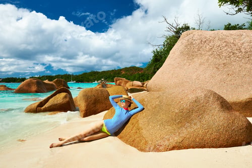 Preview: Woman At Beautiful Beach Wearing Rash Guard. Seychelles, Praslin, Anse Lazio
