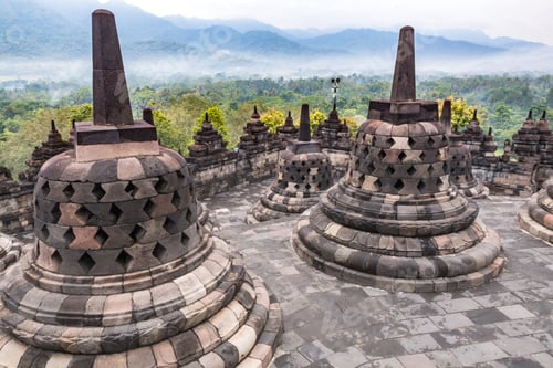 Preview: Borobudur buddhist temple with mountain and fog in the morning day in Yogyakarta, Java, Indonesia.