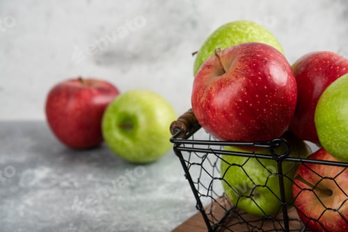 Preview: Fresh delicious green and red apples in metal basket