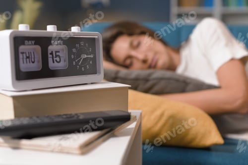Preview: Relaxed woman sleeping on the sofa at home