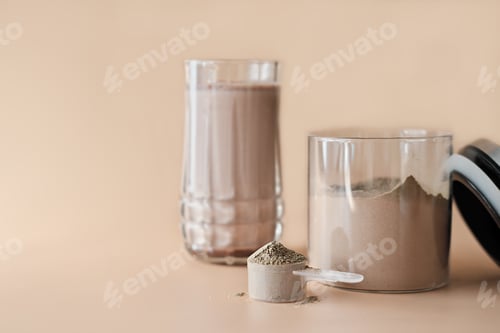 Preview: scoop of collagen peptides powder with chocolate flavor in a jar and protein shake in a glass.