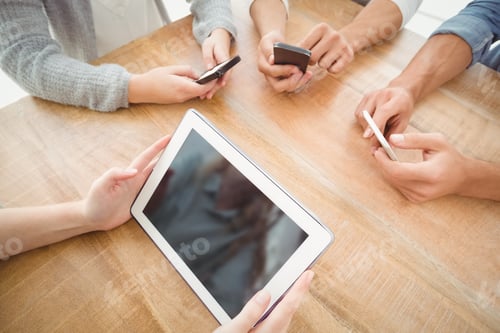 Preview: High Angle View Of Cropped Hands Using Smartphones And Digital Tablet At Desk
