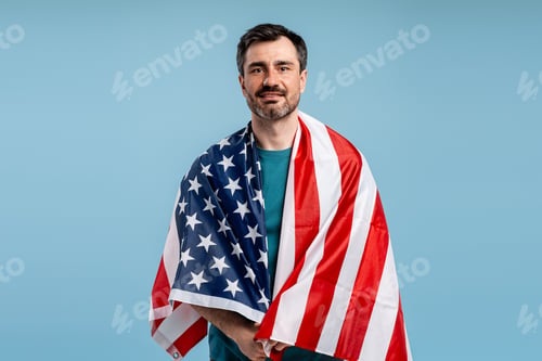 Preview: Man smiling while wrapped in the national flag, representing pride and freedom