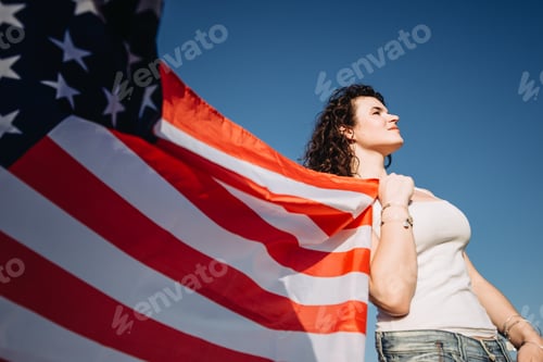 Preview: Girl with an American flag. Independence Day concept