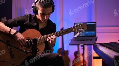 Preview: Musician in a headphones records his composition in a music Studio using professional audio.