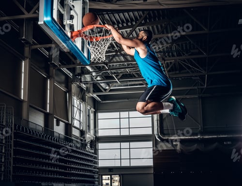 Preview: Black basketball player in action in a basketball court.