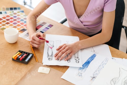 Preview: Cropped photo of caucasian woman fashion designer making sketches