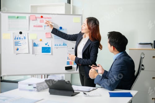 Preview: Two busy happy professional business man and woman executive leaders team using laptop working