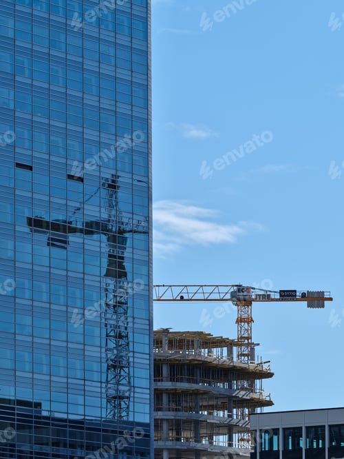 Preview: Reflection of a crane on the glass windows of the building