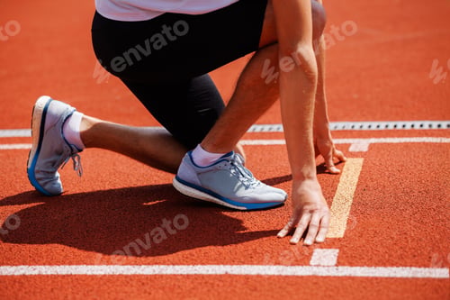 Preview: A track runner is standing at the starting line, getting ready for a quick sprint