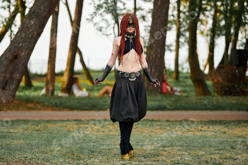 Preview: Mythological dancing girl faun on green lawn in public park outdoor art dancing event