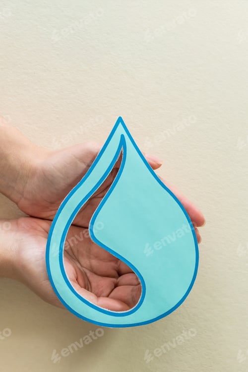 Preview: Vertical shot of female hands holding paper cut water drop on beige background