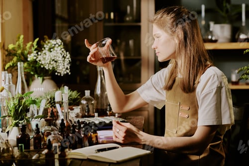 Preview: Female Perfumer Mixing Essential Oils in Lab