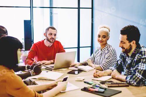 Preview: Multiethnic colleagues working together on project in workplace